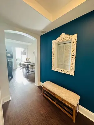 a room with a blue wall with a mirror and a bench at Ocean View 2bd2bth Hotel In Coconut Grove in Miami
