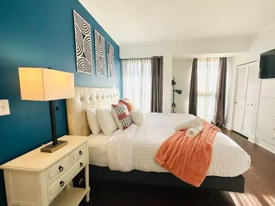 a bedroom with a white bed and a blue wall at Ocean View 2bd2bth Hotel In Coconut Grove in Miami
