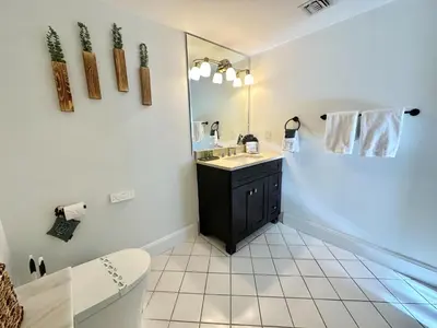 a bathroom with a sink and a mirror at Ocean View 2bd2bth Hotel In Coconut Grove in Miami