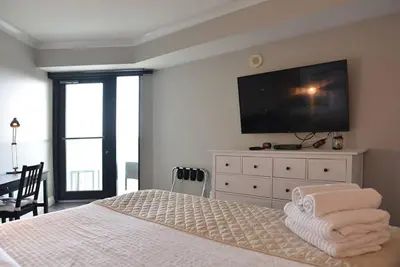 a bedroom with a bed with a flat screen tv at Sight Of Sail Boats! Tranquil 115 Coconut Grove in Miami
