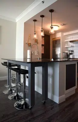 a kitchen with a sink and a counter with stools at Sight Of Sail Boats! Tranquil 115 Coconut Grove in Miami