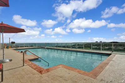 a large swimming pool on top of a building at Sight Of Sail Boats! Tranquil 115 Coconut Grove in Miami