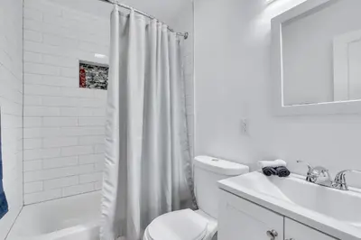 a white bathroom with a toilet and a sink at Tranquil Pool Home in Hollywood Close to Beach Airport in Hollywood