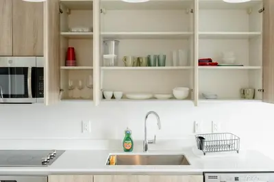 a kitchen with white cabinets and a sink at Miami design district, view of the bay - city in Miami