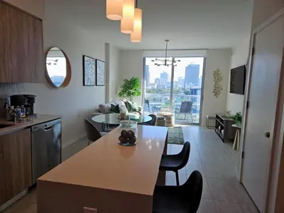 a kitchen and living room with a table and chairs at Miami design district, view of the bay - city in Miami