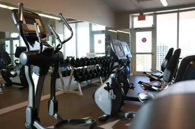 a gym with treadmills and exercise bikes in it at Amazing Studio - Walking Distance To Cocowalk in Miami