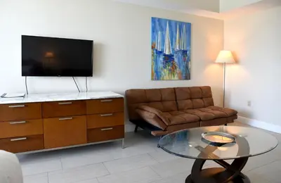 a living room with a couch and a glass table at Amazing Studio - Walking Distance To Cocowalk in Miami