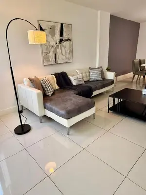 a living room with a couch and a table at SPECIAL Beautiful Modern Beach Condo in Miami Beach
