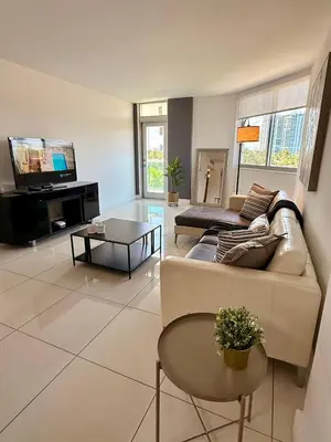 a living room with a couch and a tv at SPECIAL Beautiful Modern Beach Condo in Miami Beach