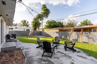 a group of chairs sitting in a yard at Cozy Miami Home Pet-friendly & with Free Parking in Miami