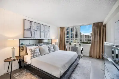 a bedroom with a bed and a view of a city at LUXURY APARTMENT - Direct Bay in South Beach in Miami Beach