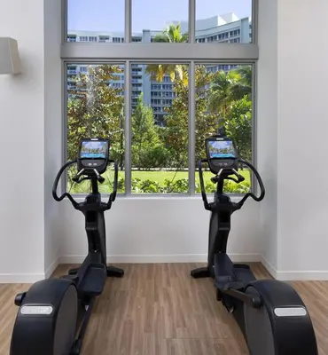 a gym with two treadmills in front of a window at LUXURY APARTMENT - Direct Bay in South Beach in Miami Beach