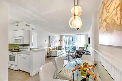 a kitchen and living room with a glass table at LUXURY APARTMENT - Direct Bay in South Beach in Miami Beach