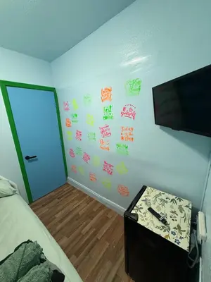 a bedroom with a bed and a wall with stickers at OQP Vacations in Miami