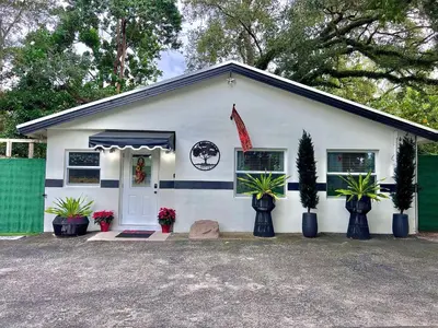 a white house with plants in front of it at The Boutique Guest House in Miami