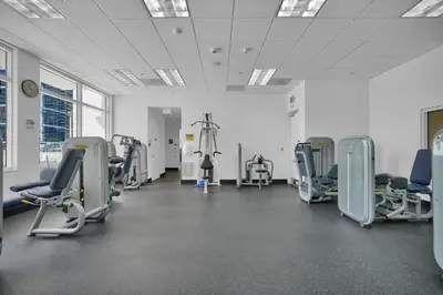 a gym with chairs and treadmills in a room at Zeus' Sanctuary Ocean View In Brickell Miami in Miami