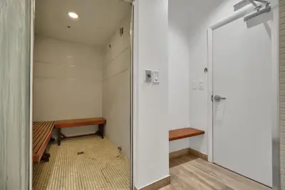a walk in shower in a room with a bench at Zeus' Sanctuary Ocean View In Brickell Miami in Miami