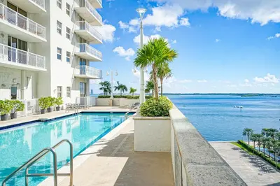 a swimming pool with a view of the ocean at Zeus' Sanctuary Ocean View In Brickell Miami in Miami