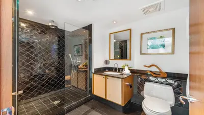 a bathroom with a shower and a toilet and a sink at Oceanview Private Townhouse at The Setai 1505-THB in Miami Beach