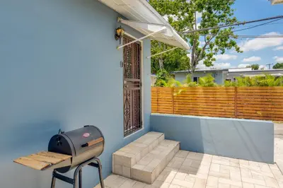 a grill sitting on the side of a house at El Portal Vacation Rental about 9 Mi to Miami! in Miami