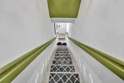 an empty escalator in a building with green accents at SOBE MONARCH 2 - 2 Bedroom 2 Bathroom Apts - 2 Independent 1 bedrooms apts in Miami Beach