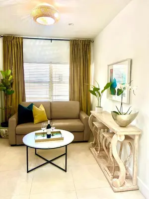 a living room with a couch and a table at SOBE MONARCH 2 - 2 Bedroom 2 Bathroom Apts - 2 Independent 1 bedrooms apts in Miami Beach