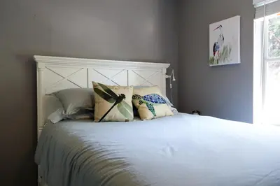 a bedroom with a large white bed with pillows at Miami Beach Villa with Sparkling Pool! Sleeps 10+! in North Miami Beach