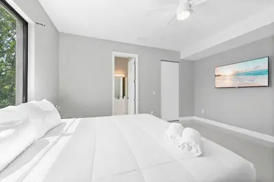 a white bedroom with a large white bed and a window at Granada Modern Luxury in Massive Mansion with Heated Pool in Miami