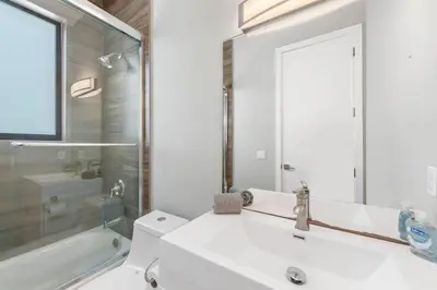 a bathroom with a sink and a toilet and a tub at Granada Modern Luxury in Massive Mansion with Heated Pool in Miami
