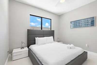 a white bedroom with a large bed and a window at Granada Modern Luxury in Massive Mansion with Heated Pool in Miami