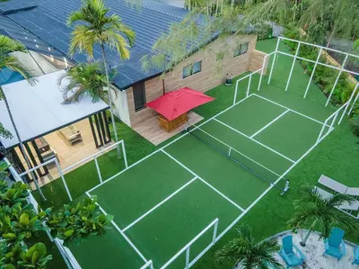 an overhead view of a tennis court with a tennis court at VillaKoBo Heated Pool Spa Bar Tennis Golf in Miami