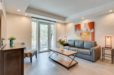 a living room with a couch and a table at Miami Beach Vacation Rental with Rooftop Pool Access in Miami Beach