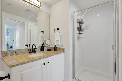 a white bathroom with a sink and a shower at Marina Bay Sunny Isles 1005 in Miami Beach