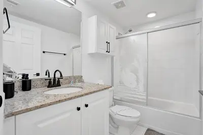 a white bathroom with a toilet and a shower at Marina Bay Sunny Isles 1005 in Miami Beach