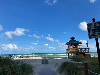 a beach with a life guard station and people on the beach at 3BR Condo in Sunny Isles Beach in Miami Beach