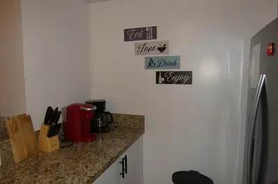 a kitchen with a counter and some signs on the wall at 3BR Condo in Sunny Isles Beach in Miami Beach