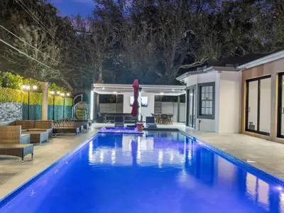 a swimming pool with a patio and a house at VillaLee Luxury Heated Pool & Spa Sauna Golf in North Miami