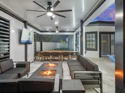 a living room with a couch and a table at VillaLee Luxury Heated Pool & Spa Sauna Golf in North Miami