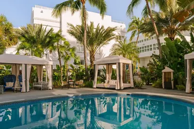 a swimming pool with a gazebo and a building at Kenmore Village Hotel, South Beach in Miami Beach