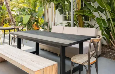 a black table and two chairs and a bench at Kenmore Village Hotel, South Beach in Miami Beach