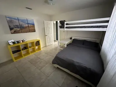 a bedroom with a bed and a bunk bed at Miami's Cozy Tropical Getaway in Miami