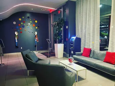 a living room with couches and a wall with a ball wall at Ocean Breeze & City Style, Miami Beach Luxury Stay -A in Hallandale Beach