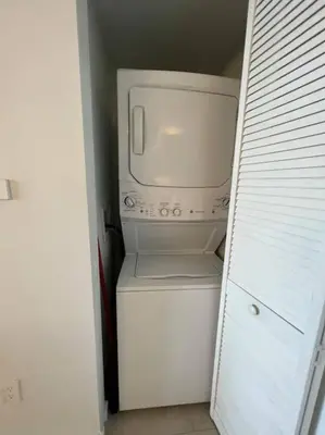 a white microwave sitting on top of a refrigerator at Ocean Breeze & City Style, Miami Beach Luxury Stay -A in Hallandale Beach