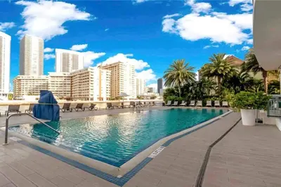 a swimming pool in the middle of a city with buildings at Ocean Breeze & City Style, Miami Beach Luxury Stay -A in Hallandale Beach