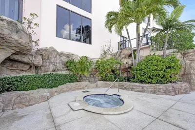 a bath tub in a garden in front of a building at Modern Miami Beach Condo with Beach Service & Pool in Miami Beach