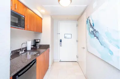 a small kitchen with a sink and a microwave at TRUMP INTERNATIONAL BEACH RESORT 2 BEDROOM APARTMENT 1600 Sqf Ocean and Bay View in Miami Beach