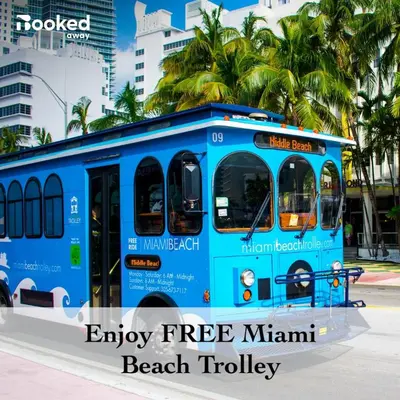 a blue bus is parked on a street at 2 BEDROOM ON THE BEACH ! in Miami Beach