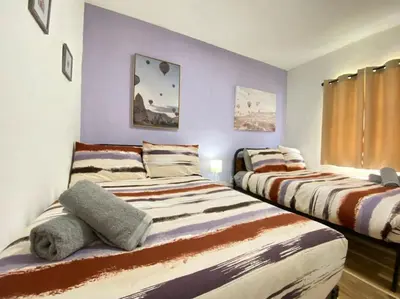 two beds in a room with purple walls at Heart of Miami sleeps 10 near Little Havana Beaches in Miami
