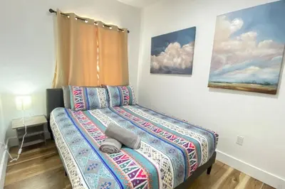 a small bedroom with a bed in a room at Heart of Miami sleeps 10 near Little Havana Beaches in Miami