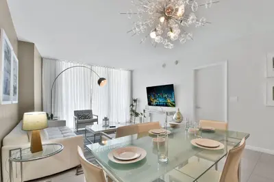 a dining room with a glass table and chairs at Water front Icon Brickell, W Hotel building in Miami